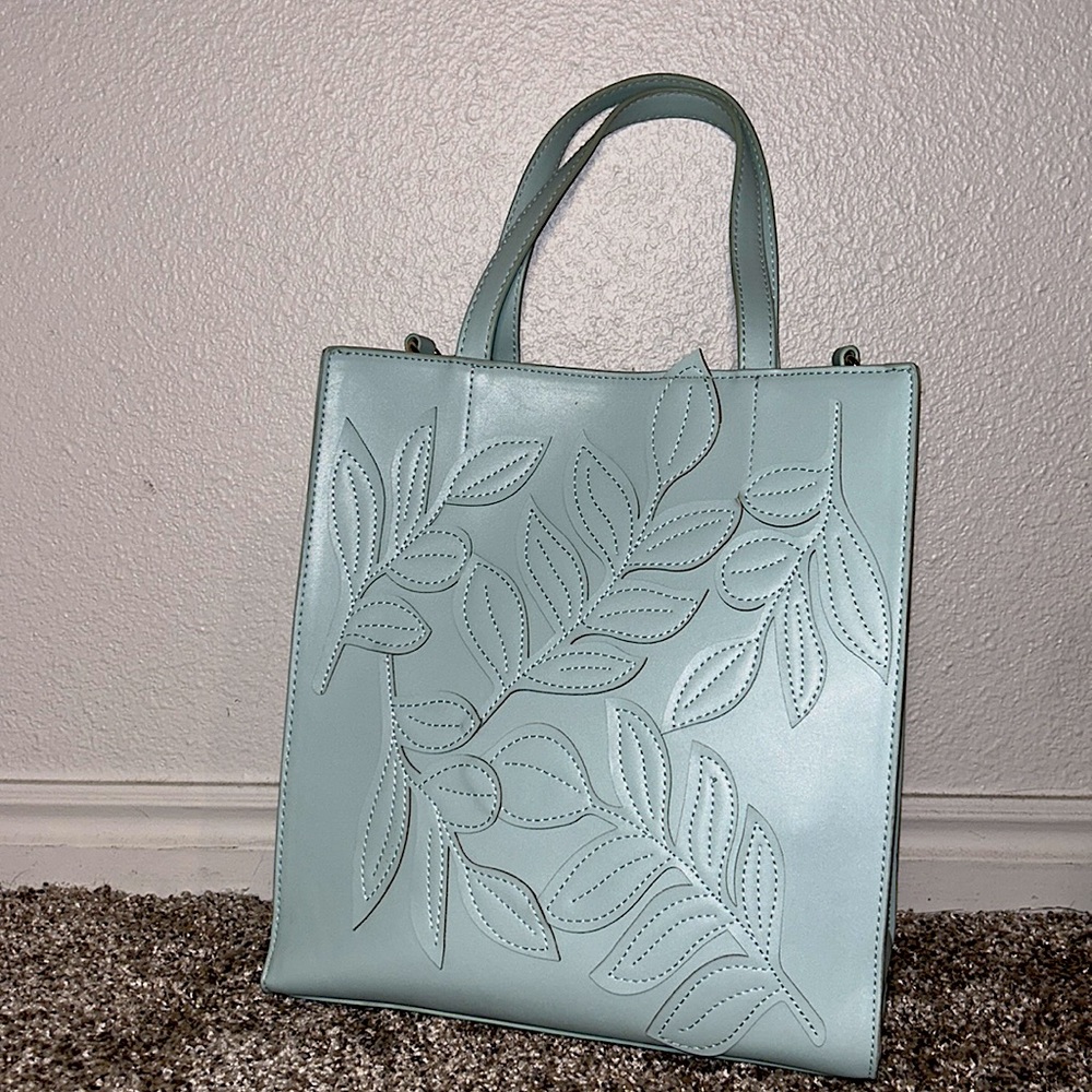 turquoise bag for women with a leaf desing and golden details